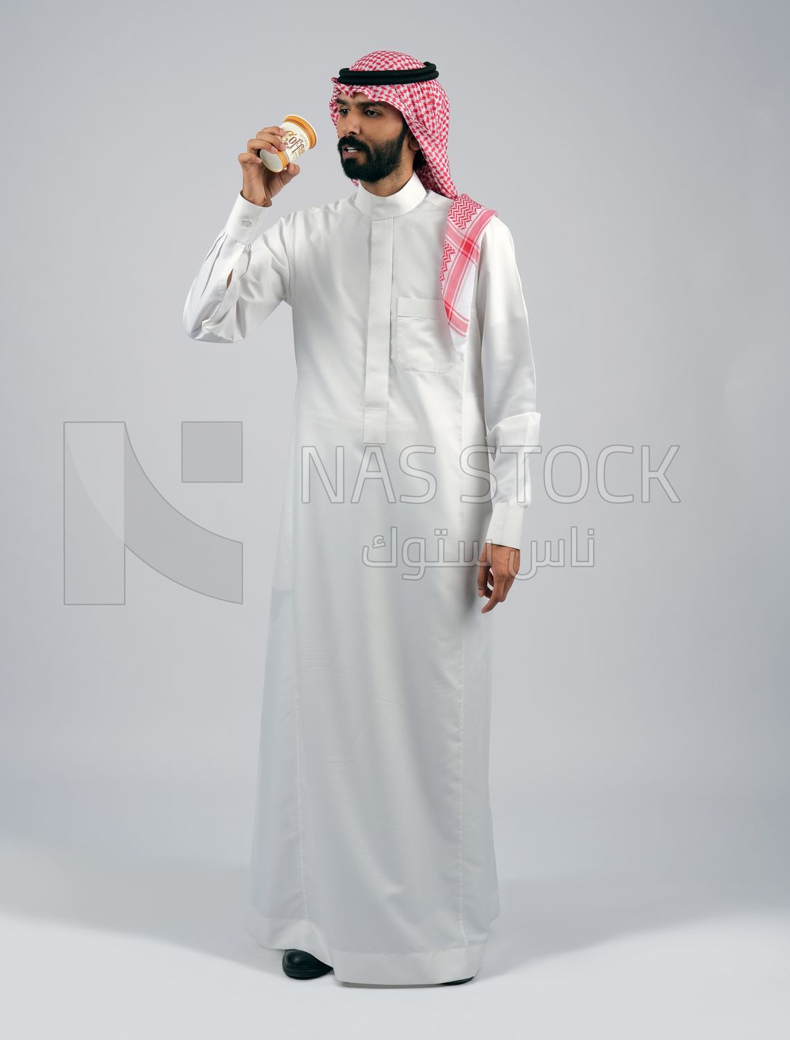 Gulf man holding a cup of coffee