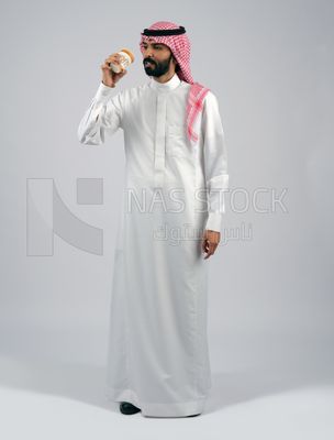 Gulf man holding a cup of coffee