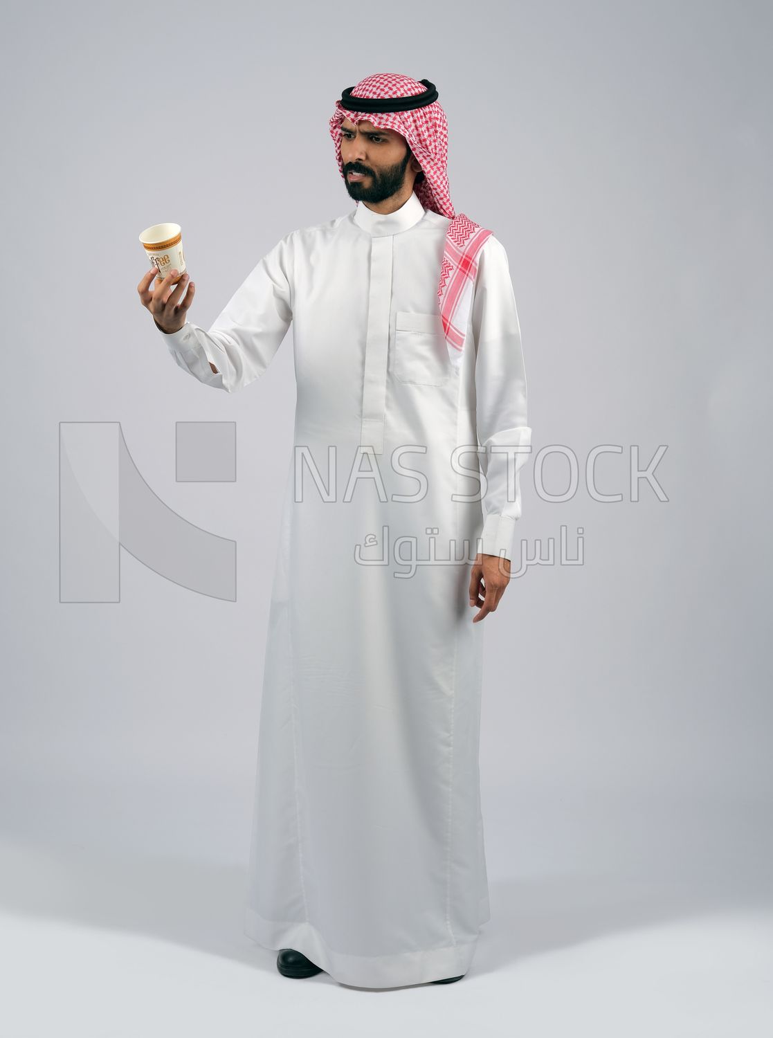 Gulf man holding a cup of coffee