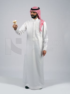 Gulf man holding a cup of coffee