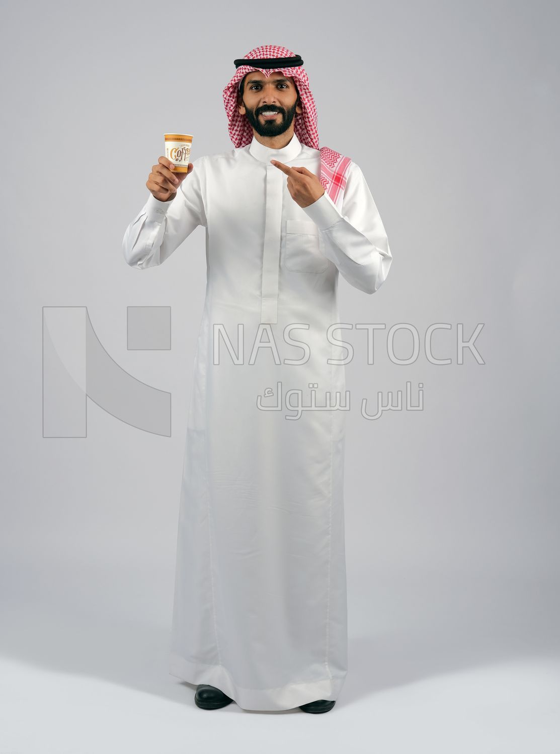 Gulf man holding a cup of coffee