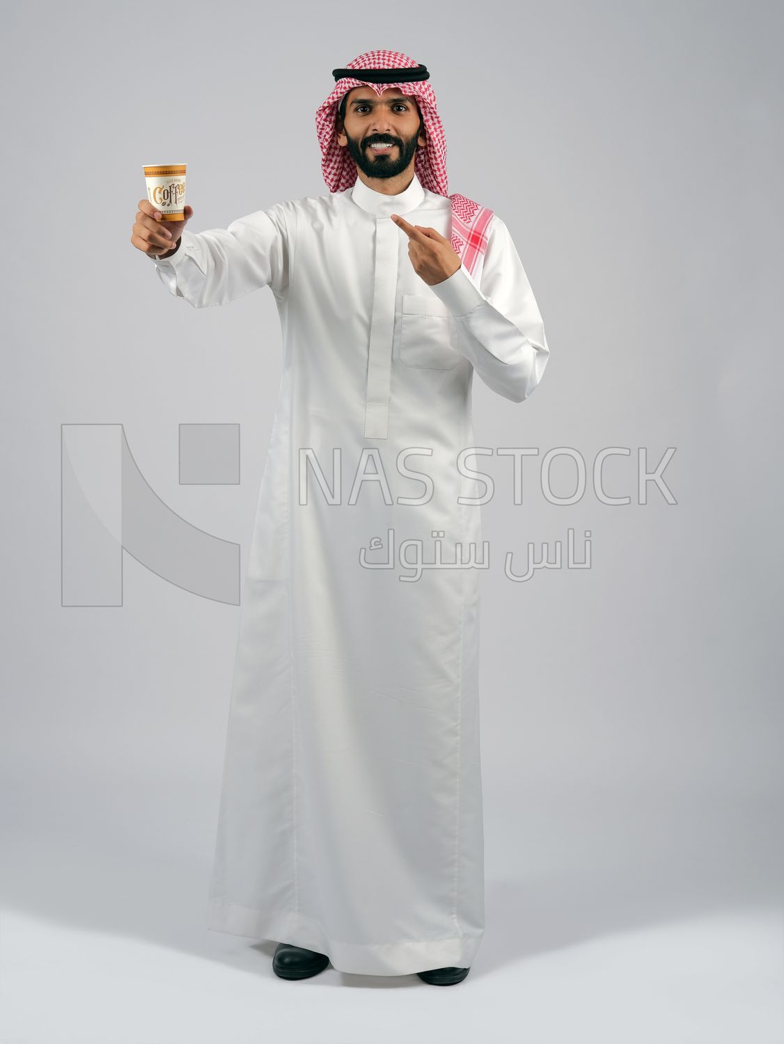 Gulf man holding a cup of coffee