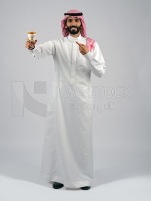Gulf man holding a cup of coffee