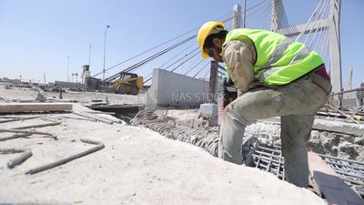 Worker using a drill to make a hole in the ground