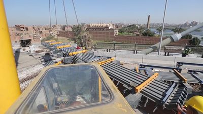 Group of engineers trying to put a part of a bridge to complete it, work, construction, engineering tools and equipment