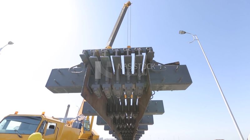 Group of engineers trying to put a part of a bridge to complete it, work, construction, engineering tools and equipment