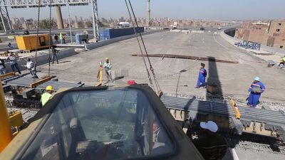 Group of engineers trying to put a part of a bridge to complete it, work, construction, engineering tools and equipment