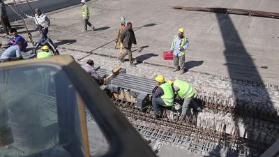 Group of engineers trying to put a part of a bridge to complete it, work, construction, engineering tools and equipment