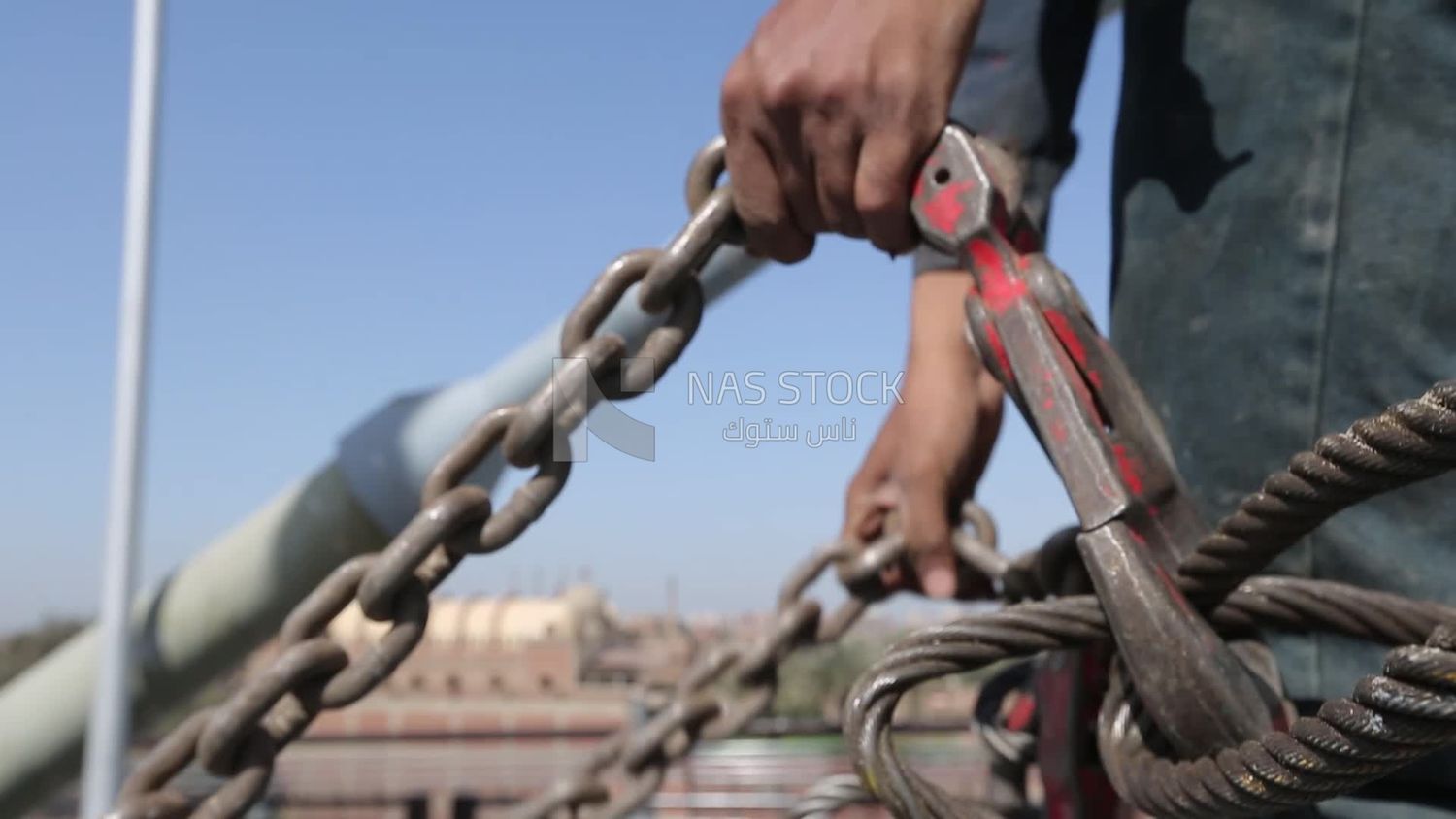 Worker trying to put the steel on a steel wire rope, work, construction, engineering tools and equipment
