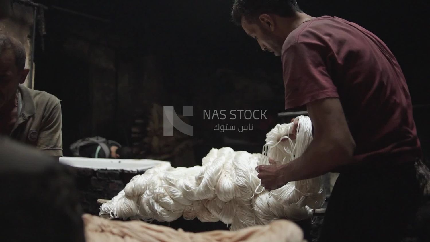 Man working in a yarn dyeing workshop
