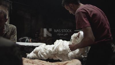 Man working in a yarn dyeing workshop