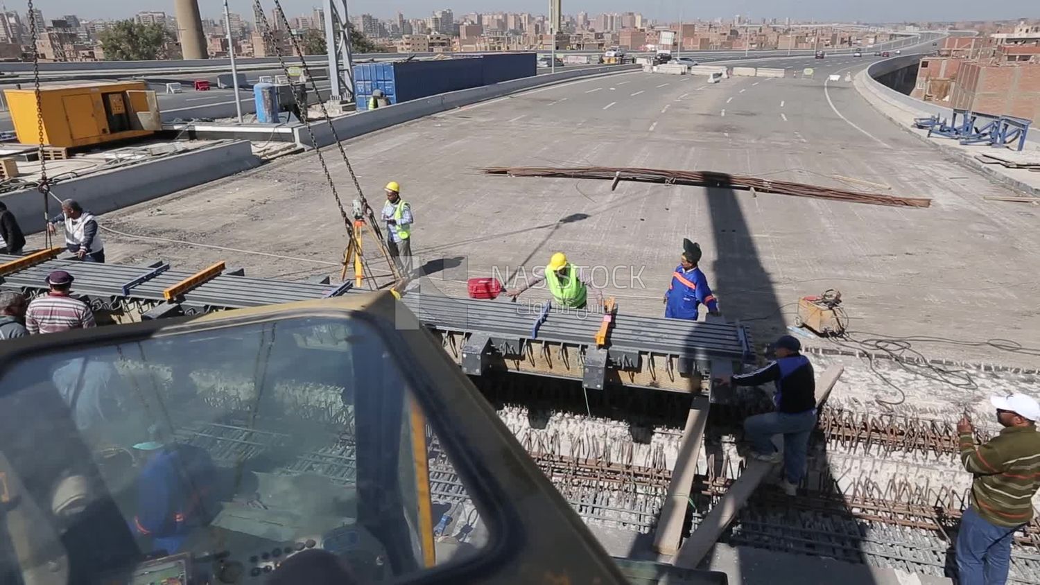 Group of engineers trying to put a part of a bridge to complete it, work, construction, engineering tools and equipment