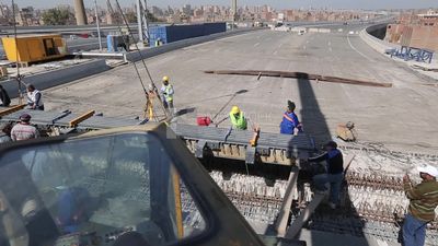 Group of engineers trying to put a part of a bridge to complete it, work, construction, engineering tools and equipment