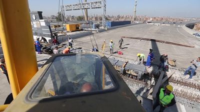 Group of engineers trying to put a part of a bridge to complete it, work, construction, engineering tools and equipment