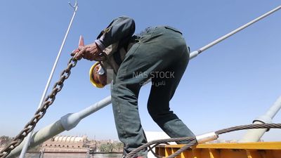Worker trying to put the steel on a steel wire rope, work, construction, engineering tools and equipment