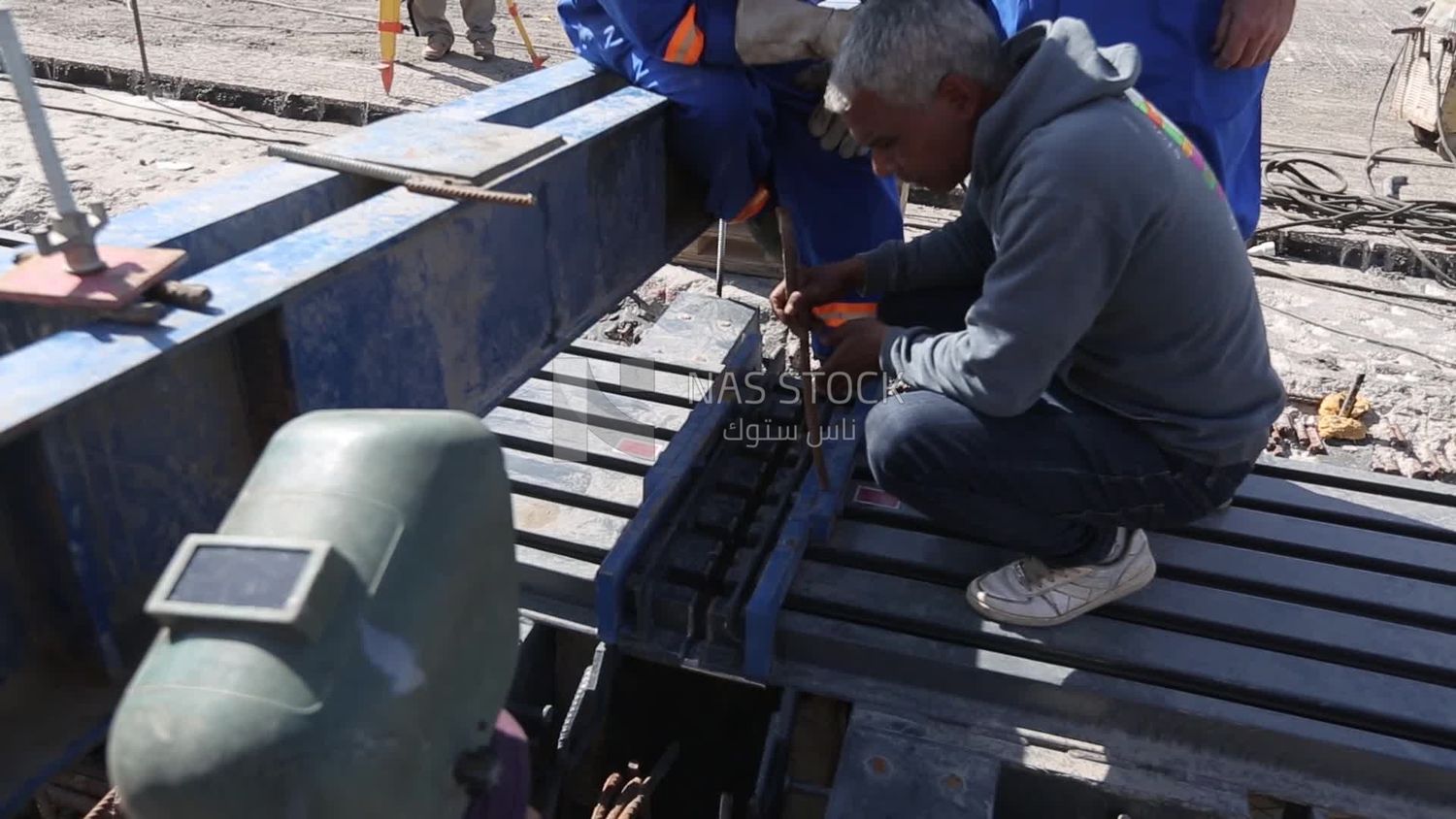 Group of engineers trying to put a part of a bridge to complete it, work, construction, engineering tools and equipment