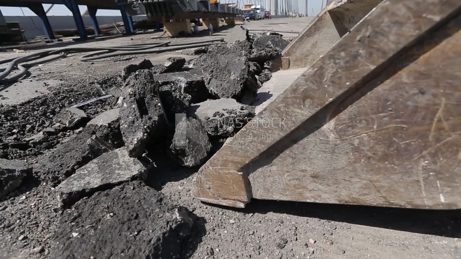Tractor lifts a stone from the ground on a building site, engineering tools and equipment
