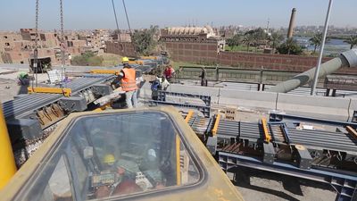 Group of engineers trying to put a part of a bridge to complete it, work, construction, engineering tools and equipment