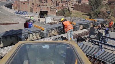 Group of engineers trying to put a part of a bridge to complete it, work, construction, engineering tools and equipment