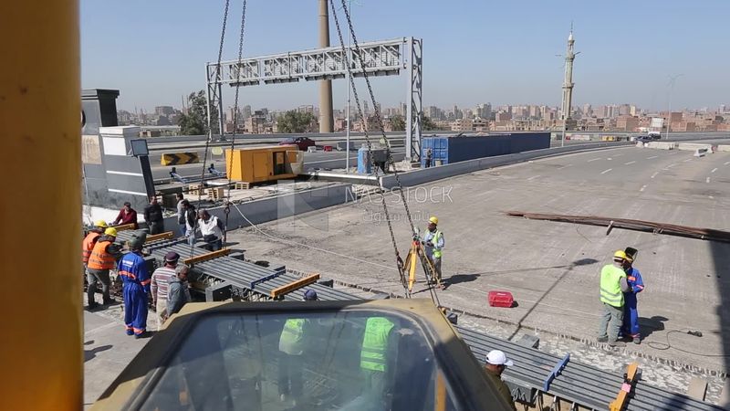 Group of engineers trying to put a part of a bridge to complete it, work, construction, engineering tools and equipment