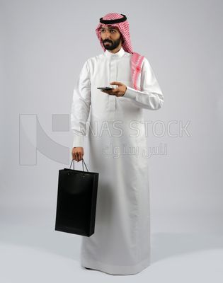 Gulf man carrying black shopping bag