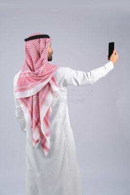 Gulf man holding a mobile phone