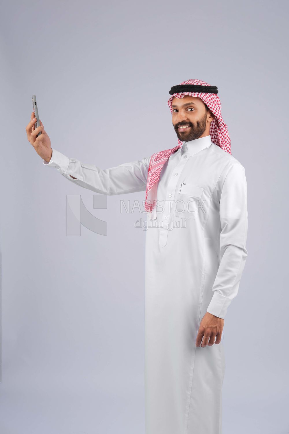 Gulf man holding a mobile phone