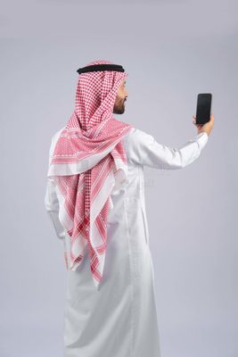 Gulf man holding a mobile phone