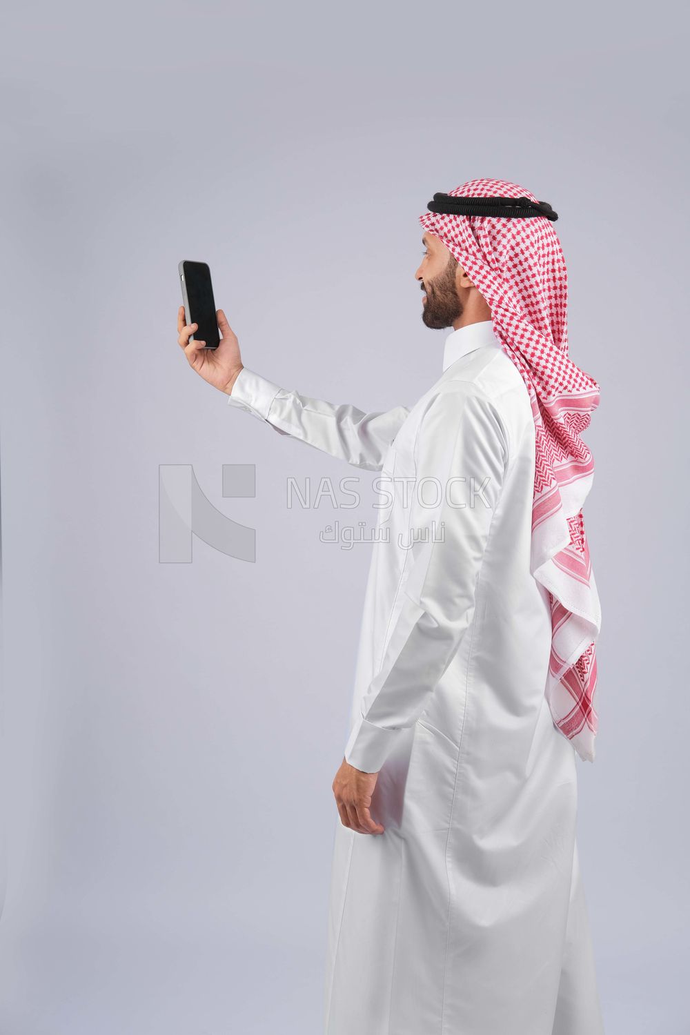 Gulf man holding a mobile phone