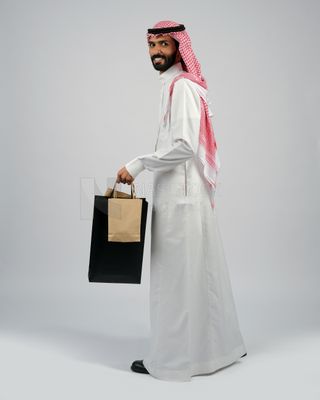 Gulf man carrying shopping bags