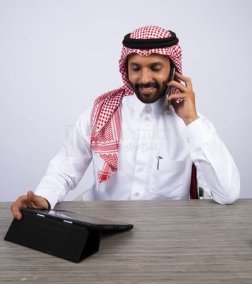 Gulf man making a call and using a tablet