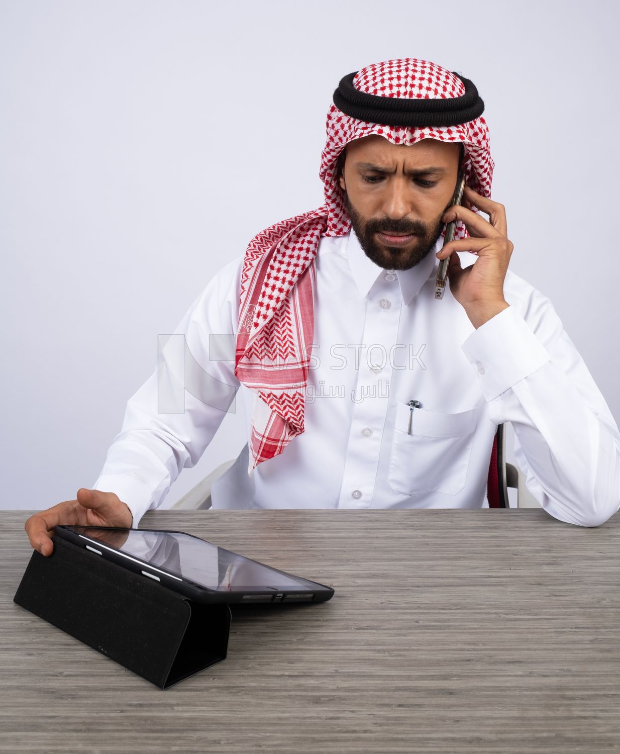 Gulf man making a call and using a tablet