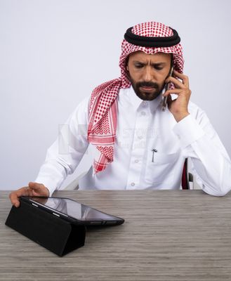 Gulf man making a call and using a tablet