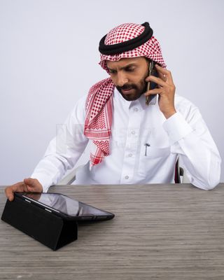 Gulf man making a call and using a tablet