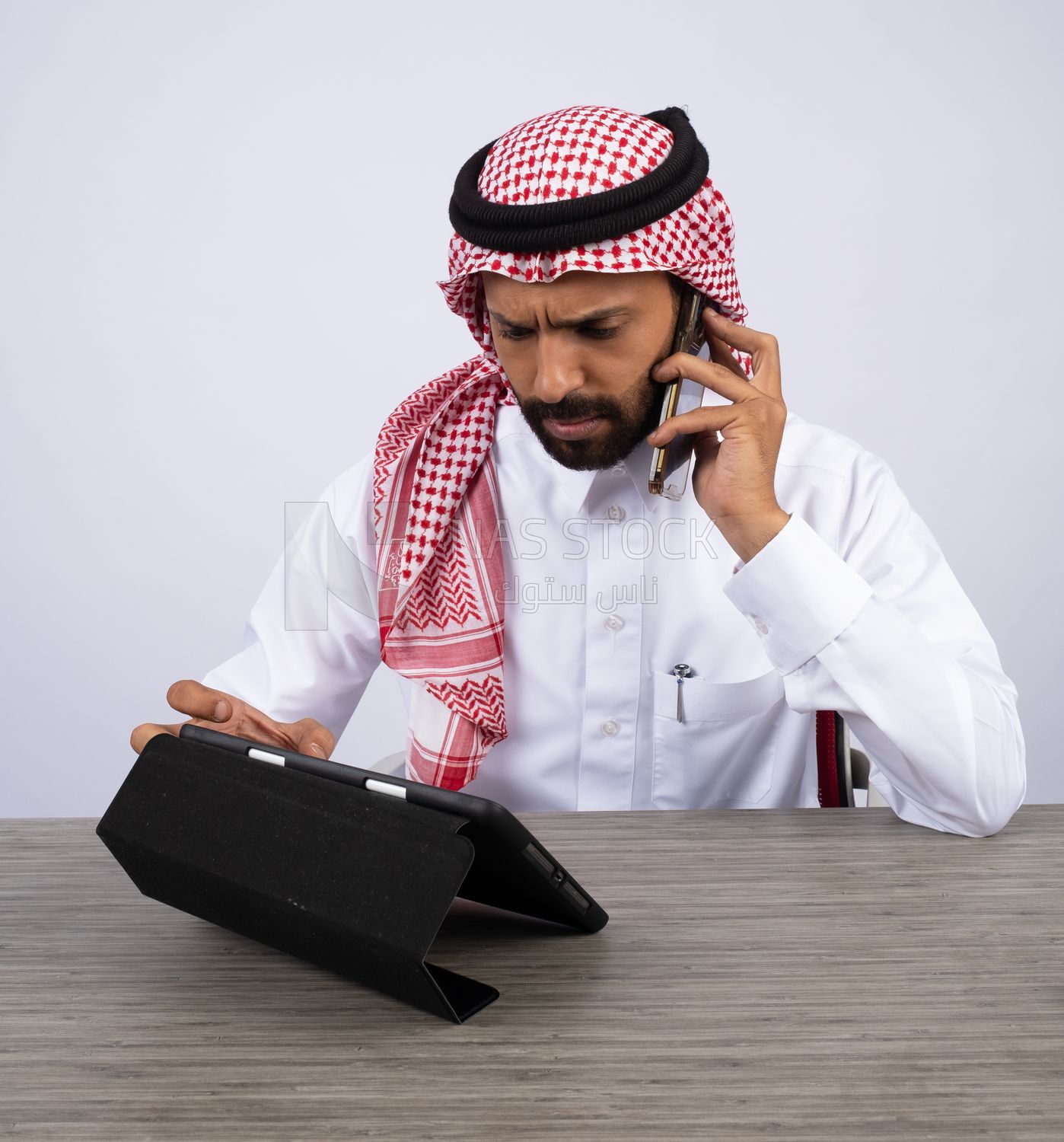 Gulf man making a call and using a tablet