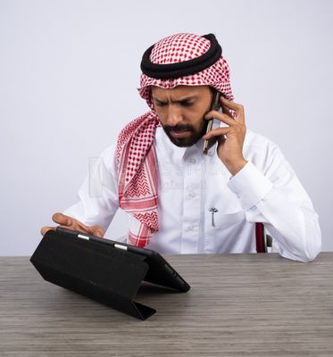Gulf man making a call and using a tablet