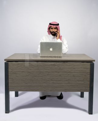 Gulf man sitting at desk using laptop
