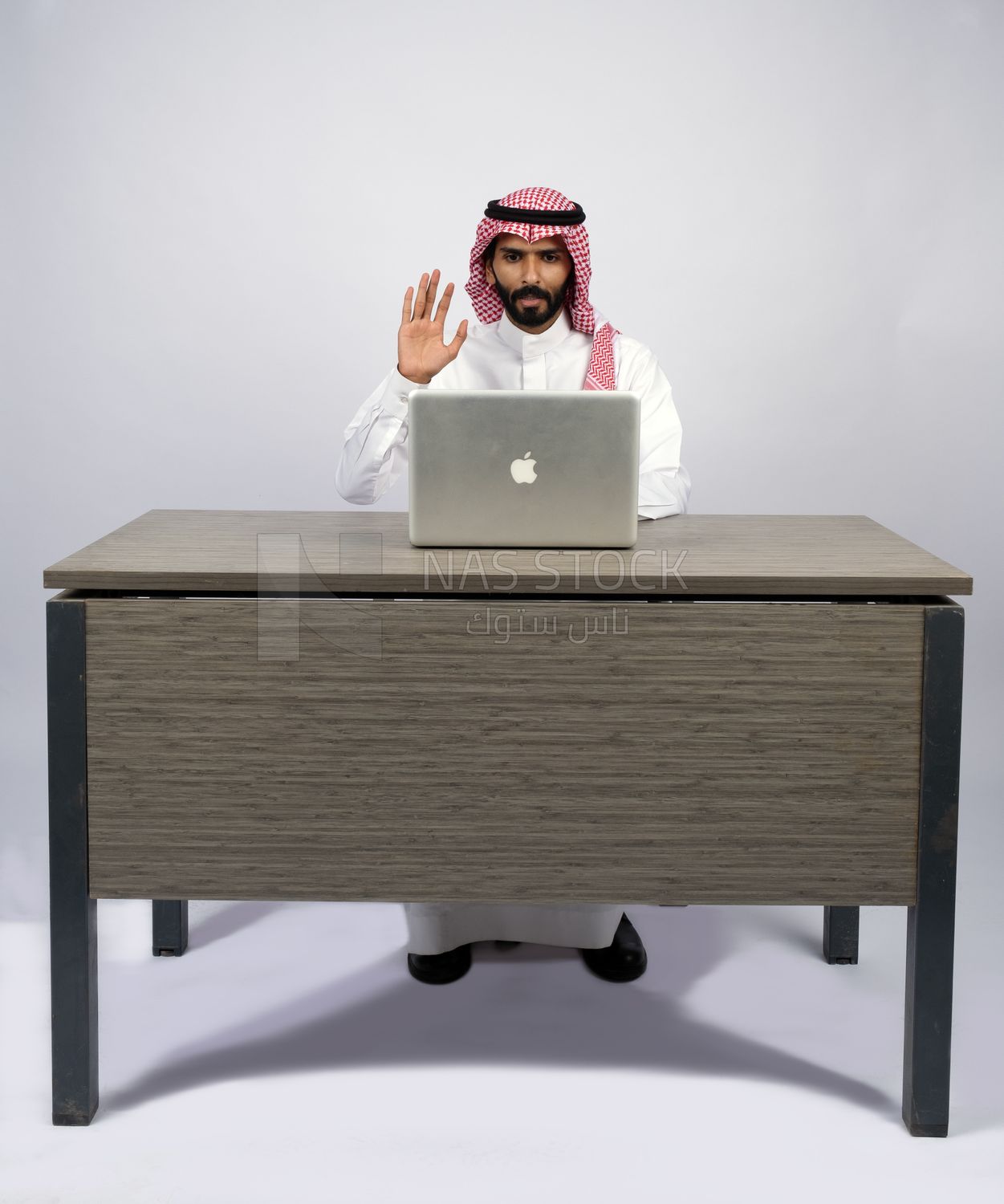 Gulf man sitting at desk using laptop