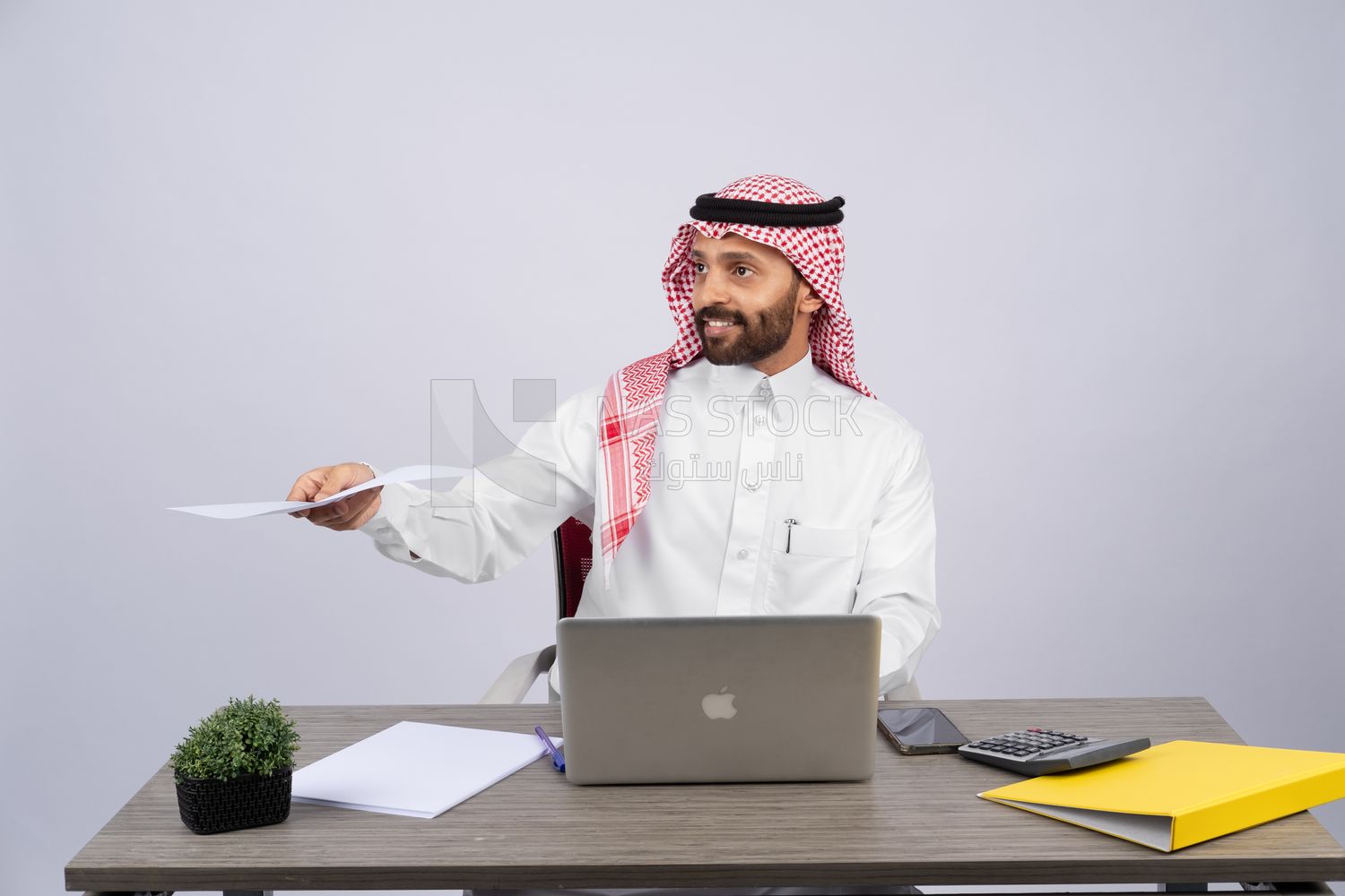 Gulf man sitting at desk using laptop