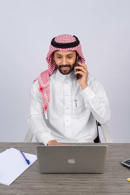 Gulf man sitting at desk using laptop