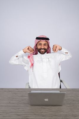 Gulf man sitting at desk using laptop