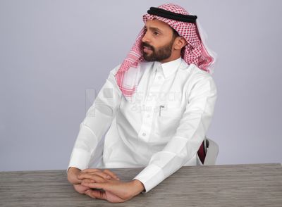 Gulf man sitting at desk