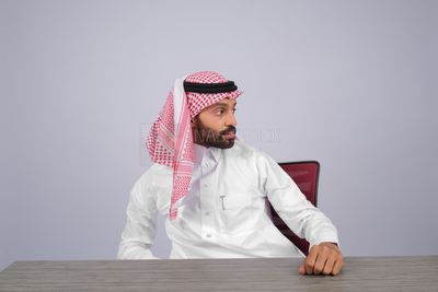 Gulf man sitting at desk