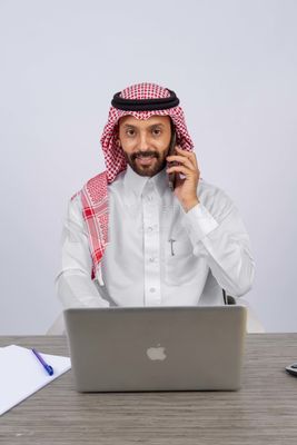 Gulf man sitting at desk using laptop