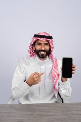Gulf man holding a mobile phone