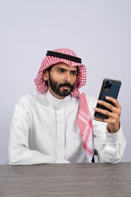 Gulf man browsing the phone