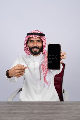 Gulf man holding a mobile phone