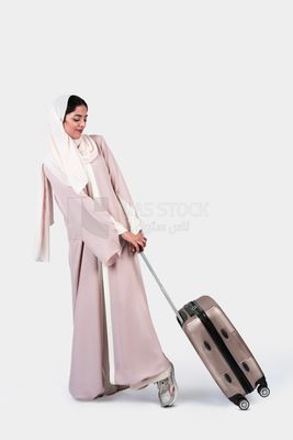Veiled Gulf girl with suitcase