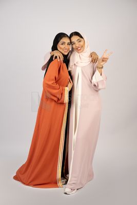 Two Gulf girls wearing modern Gulf abayas