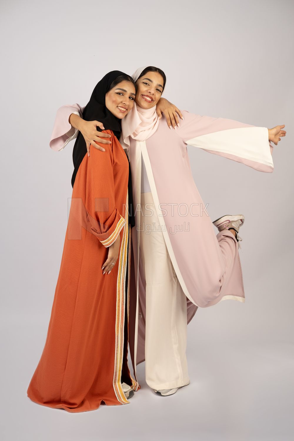 Two Gulf girls wearing modern Gulf abayas